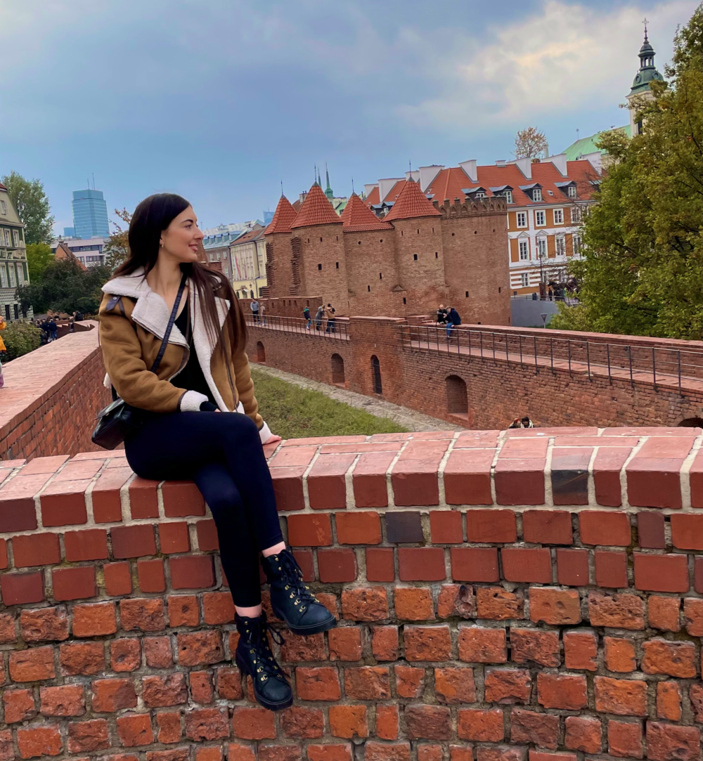 Liz Kennedy sitting on a wall in Warsaw